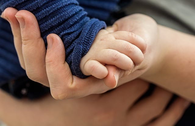 Trust: Baby is holding moms hand