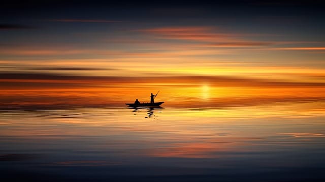 You cannot swim: small boat in a sea while sunset.