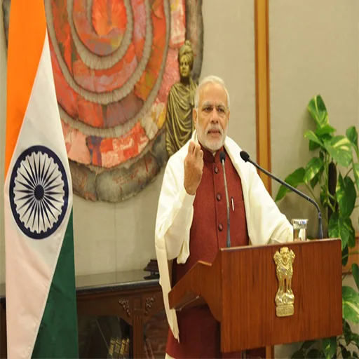 PM Modi standing at a podium on a national broadcast