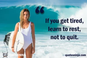 Girl stands on the beach, holding her surfboard